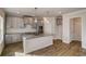 Open kitchen with gray cabinets, granite countertops and center island with sink at 3870 Ivy Cottage Dr, Snellville, GA 30039