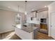Bright kitchen with island, granite countertops, and stainless-steel sink at 3870 Ivy Cottage Dr, Snellville, GA 30039
