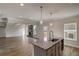 Open-concept kitchen with granite countertops and modern appliances that flows into an ample living space at 3870 Ivy Cottage Dr, Snellville, GA 30039
