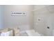 Bright laundry room with shelving, washer hookups, and decorative 'Laundry Co.' sign at 3870 Ivy Cottage Dr, Snellville, GA 30039