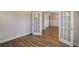 Open living space with hardwood floors and french doors that lead into other room at 3870 Ivy Cottage Dr, Snellville, GA 30039