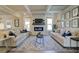 Bright living room featuring hardwood floors, a fireplace, and stylish neutral furniture at 3870 Ivy Cottage Dr, Snellville, GA 30039