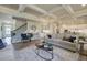 Open-concept living room with fireplace, hardwood floors, coffered ceilings, and seamless flow at 3870 Ivy Cottage Dr, Snellville, GA 30039