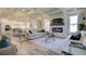 Spacious open-concept living room with fireplace, hardwood floors, and views of kitchen at 3870 Ivy Cottage Dr, Snellville, GA 30039