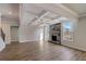 Open living area featuring a stone fireplace, coffered ceilings, and hardwood floors at 3870 Ivy Cottage Dr, Snellville, GA 30039