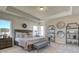 Elegant main bedroom with tray ceilings, accent wall, decorative shelving and a neutral color palette at 3870 Ivy Cottage Dr, Snellville, GA 30039