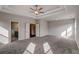 Main bedroom boasting tray ceiling, carpet, generous space, and bright windows at 3870 Ivy Cottage Dr, Snellville, GA 30039
