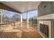 Relax on this covered porch with a wooden floor and fireplace perfect for enjoying the outdoors at 3870 Ivy Cottage Dr, Snellville, GA 30039