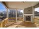 Covered porch with wooden floors and fireplace offering scenic backyard views at 3870 Ivy Cottage Dr, Snellville, GA 30039