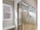 Elegant bathroom boasts marble tiling and frameless glass shower, offering a luxurious spa-like experience at 3870 Ivy Cottage Dr, Snellville, GA 30039