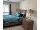 Comfortable bedroom featuring a blue comforter on the bed and natural light from the window at 8740 Roswell Rd # 5G, Sandy Springs, GA 30350
