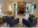 Cozy living room featuring comfortable seating, a stone fireplace, and natural light at 8740 Roswell Rd # 5G, Sandy Springs, GA 30350