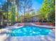 Community pool with sundeck and mature trees at 8740 Roswell Rd # 5G, Sandy Springs, GA 30350