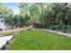 Well-maintained backyard features a manicured lawn, a privacy fence, and mature trees at 95 Lakeshore Ne Cir, Marietta, GA 30067