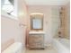 Bathroom featuring a rustic vanity, framed mirror, and tiled shower at 95 Lakeshore Ne Cir, Marietta, GA 30067