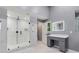 Luxurious bathroom featuring a glass shower, gray vanity, and marble floors at 95 Lakeshore Ne Cir, Marietta, GA 30067