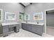 Bathroom featuring dual vanity sinks, lighted mirrors, and gray cabinetry at 95 Lakeshore Ne Cir, Marietta, GA 30067