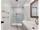 Modern bathroom boasts glass shower, white vanity, framed mirror, and neutral tile at 95 Lakeshore Ne Cir, Marietta, GA 30067