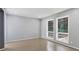 Neutral bedroom with hardwood floors and natural light from the two large windows at 95 Lakeshore Ne Cir, Marietta, GA 30067