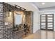 Stylish entryway featuring a brick accent wall, decorative mirror, and modern lighting fixtures at 95 Lakeshore Ne Cir, Marietta, GA 30067