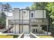 Modern home showcasing a spacious deck, stone accents, and stairs leading to the main entrance at 95 Lakeshore Ne Cir, Marietta, GA 30067