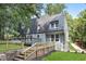 Exterior view of a home with metal roof, a stone foundation, and stairs leading to yard at 95 Lakeshore Ne Cir, Marietta, GA 30067