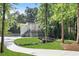 Stunning two-story home on a lush, tree-lined lot, complete with a long driveway and outdoor deck at 95 Lakeshore Ne Cir, Marietta, GA 30067