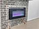 Unique brick fireplace with a modern built-in electric fireplace at 95 Lakeshore Ne Cir, Marietta, GA 30067
