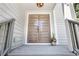 Inviting front entrance with modern double doors, complemented by a stylish light fixture and steps at 95 Lakeshore Ne Cir, Marietta, GA 30067