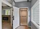 Bright hallway featuring an in-home elevator and a fireplace in the adjacent room, providing accessibility and warmth at 95 Lakeshore Ne Cir, Marietta, GA 30067