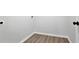 A laundry room with white walls, wood floors, and a dark door handle at 95 Lakeshore Ne Cir, Marietta, GA 30067