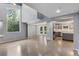 Open living space with high ceilings, exposed beams, hardwood floors, and flows into kitchen at 95 Lakeshore Ne Cir, Marietta, GA 30067