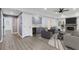 Open-concept living room features gray cabinets, brick fireplace, ceiling fan and light, and hardwood floors at 95 Lakeshore Ne Cir, Marietta, GA 30067