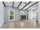 Spacious living room with vaulted ceiling, wood beams, fireplace, and large windows at 95 Lakeshore Ne Cir, Marietta, GA 30067