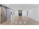 Open-concept living room with a striking brick fireplace, modern sliding barn door, and hardwood floors at 95 Lakeshore Ne Cir, Marietta, GA 30067
