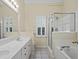 Bright bathroom featuring double sink vanity, shower with glass door, and soaking tub at 207 Bent Oak Ln, Woodstock, GA 30189