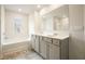 Bathroom showcasing double sinks, tub, and large mirror for a luxurious feel at 288 Highgrove Way, Dallas, GA 30157