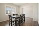 Bright dining room features dark wood floors, a large window and a dining table at 288 Highgrove Way, Dallas, GA 30157