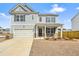 Charming two-story home featuring a welcoming front porch and a well-manicured lawn on a sunny day at 288 Highgrove Way, Dallas, GA 30157