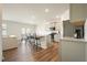 Open-concept kitchen with an island, stainless appliances, and barstool seating, flowing into the dining and living area at 288 Highgrove Way, Dallas, GA 30157