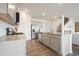 Well-lit kitchen featuring stainless steel appliances, granite counters, and a breakfast bar with seating at 288 Highgrove Way, Dallas, GA 30157