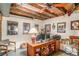 This finished basement features exposed wood ceiling, painted brick wall, fan, and several posters at 3780 Clubview Se Ct, Conyers, GA 30094