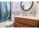 Bathroom featuring a marble countertop, a vanity, and a shower with a blue curtain at 3780 Clubview Se Ct, Conyers, GA 30094