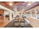 Dining area with long table adjacent to the kitchen featuring a unique ceiling and lots of natural light at 3780 Clubview Se Ct, Conyers, GA 30094