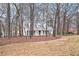 Exterior view of this charming home on a wooded lot with mature trees and a circular driveway at 3780 Clubview Se Ct, Conyers, GA 30094