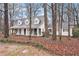 Attractive home on a wooded lot featuring a charming front porch with rocking chairs and a swing at 3780 Clubview Se Ct, Conyers, GA 30094