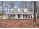 Charming home featuring a welcoming front porch with rocking chairs and swing, and a manicured front yard at 3780 Clubview Se Ct, Conyers, GA 30094