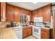 Cozy kitchen showcasing wooden cabinets, modern appliances, and a window offering a view of the outdoors at 3780 Clubview Se Ct, Conyers, GA 30094