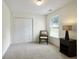 Bedroom with neutral carpet, double door closet, and window that provides natural light at 8237 Eastshore Dr, Union City, GA 30291