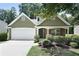 Charming home featuring an attached two car garage, landscaped front yard and inviting front porch at 8237 Eastshore Dr, Union City, GA 30291